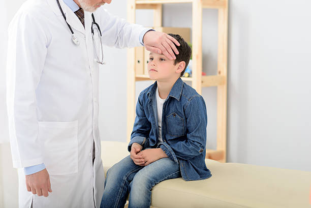 istock Pediatrician checking temperature of sick patient 543060336