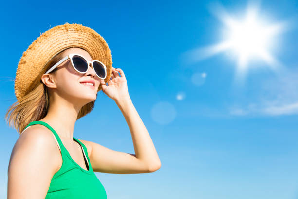 Young  woman relaxing and watching sunlight at summer