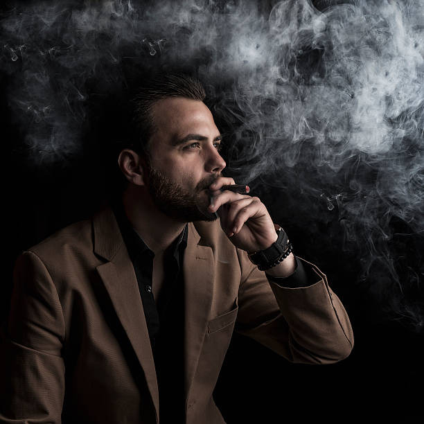 eleganter mann rauchen - smoking smoking issues cigarette addiction stock-fotos und bilder