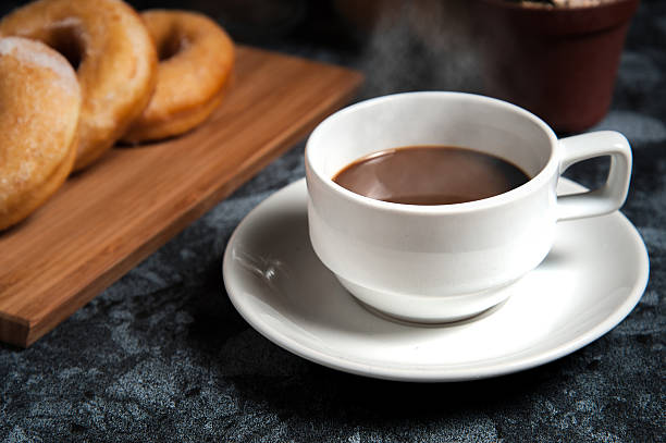 istock Cup of coffee with delicious donuts 543062032