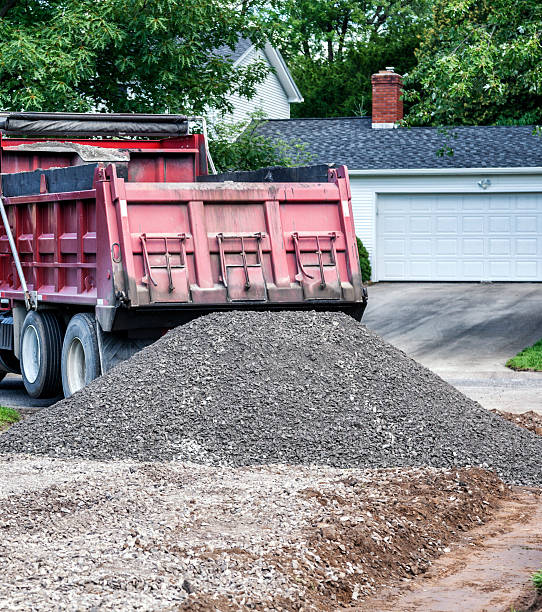 istock Dump Truck Unloading Gravel For Suburban Home New Driveway Construction 543062438