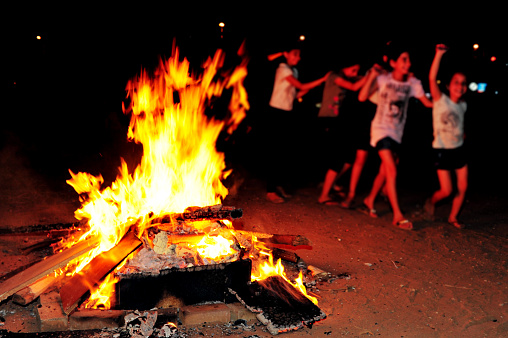 Sderot, Israel - May 21, 2011: Israeli youth celebrate by a bonfire the Jewish holiday of Lag Baomer in Sderot, Israel. It's a festive day on the Jewish calendar to commemorate the death of Rabbi Shimon Bar Yochai.
