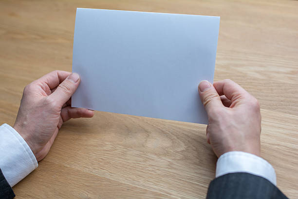 istock businessman holding white blank paper 543064618