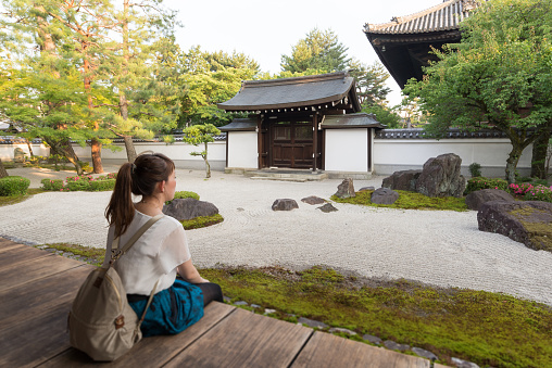 Japanese young woman looking at Kyoto Hyakumanben Chionji Temple Garden