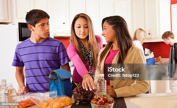 Relationships Foster Home Teens In Kitchen Making Lunches Stock Photo - Download Image Now