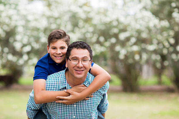 istock Latin father carrying latin son and smiling at the camera 543066778