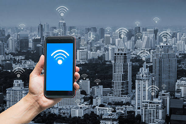 istock hand holding smart phone and wifi concept 543067202