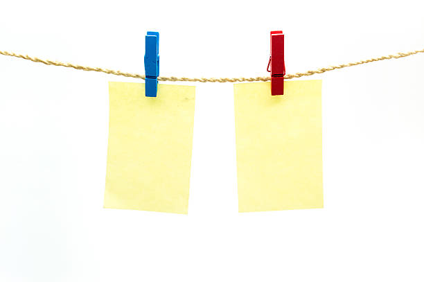 istock Red and blub clothespins and yellow note paper 543067608
