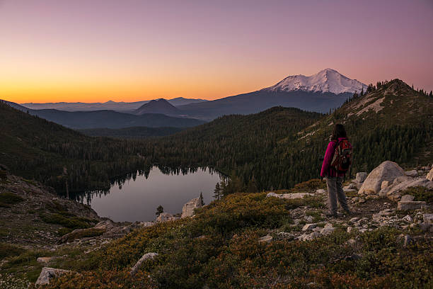 hiker watching sunset on the mountain. - mt lassen imagens e fotografias de stock