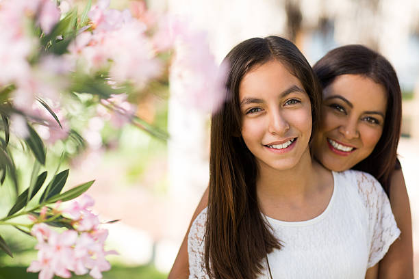 istock Beautiful latin mother and daughter smiling at camera 543068730