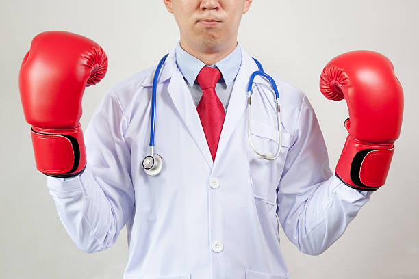 asian doctor wearing boxing gloves in white background - immune defence fotos imagens e fotografias de stock