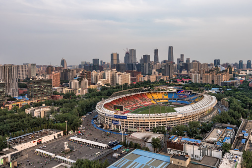 Beijing,China-June 12th,2016：Fans are entering Beijing Workers' Stadium to watch a football game, next to Beijing Workers Stadium is famous for building CBD.