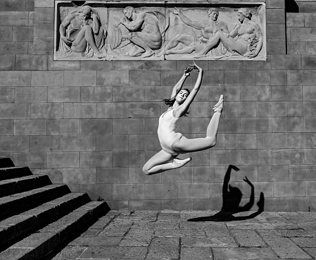 Ballet dancer jumping in the city