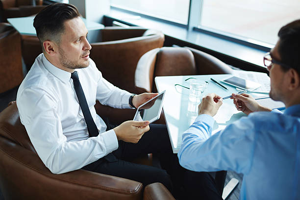 istock Pensive businessman with touchpad 543073000