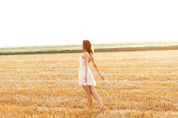 istock Beautiful young woman with hat in the field 543073146