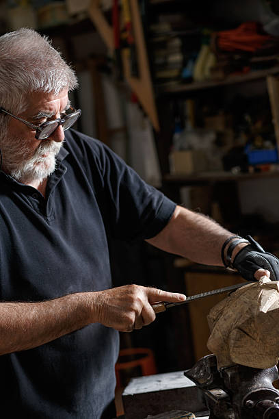 istock Senior sculptor working on his sculpture 543076444