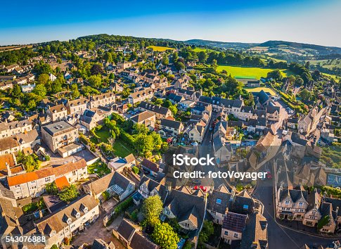 istock Aerial view over pretty rural village cottages summer fields Cotswolds 543076888
