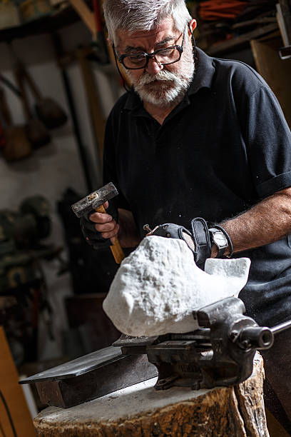 istock Senior sculptor working on his sculpture 543077534