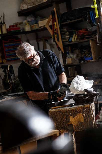 istock Senior sculptor working on his sculpture 543079014