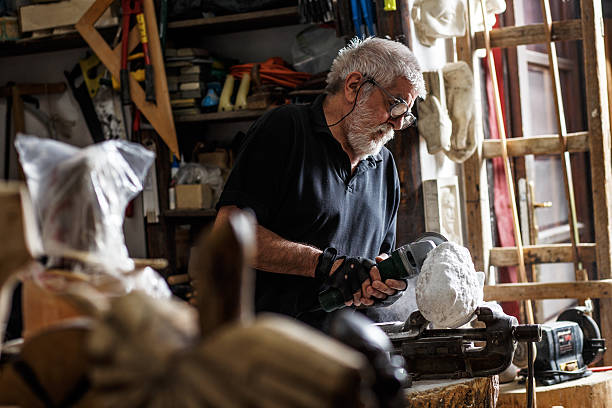 istock Senior sculptor working on his sculpture 543079204