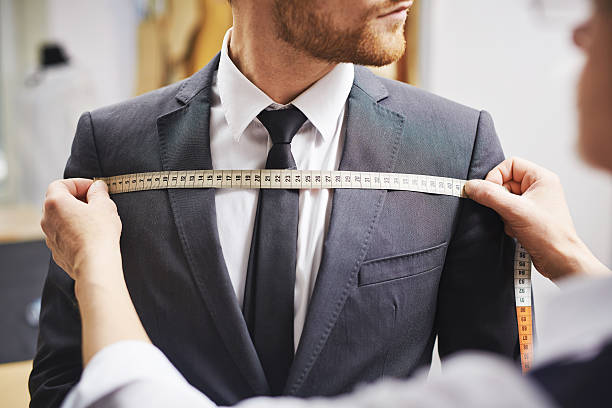 Measuring front of jacket Tailor measuring front of businessman jacket tailor photos stock pictures, royalty-free photos & images