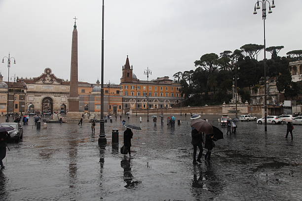 Rome, Italy - March 18, 2013: Commuters are walking in Rome old city center, Italy. Rome's architecture over the  centuries has greatly developed, especially from the Classical and Imperial Roman styles to modern Fascist  architecture.