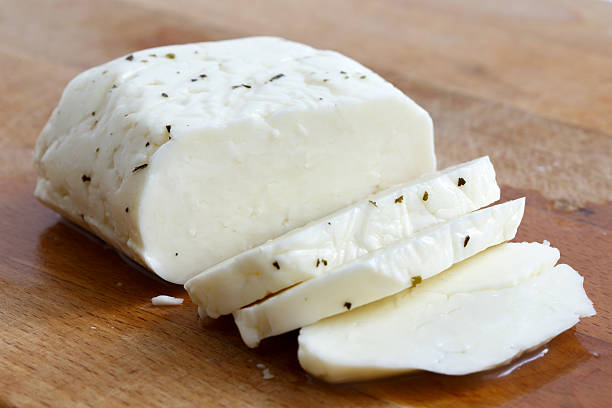 istock Sliced halloumi cheese with mint on wooden board in perspective. 543080678