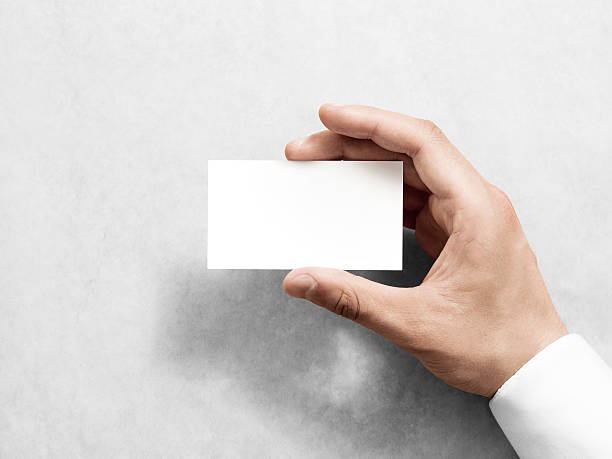 istock Hand holding blank plain white business card design mockup. 543081342