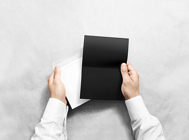 istock Hand holding blank envelope and black letter mockup, isolated. 543082054