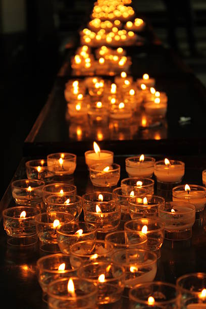 istock Many candles in small glasses glowing in dark 543083304