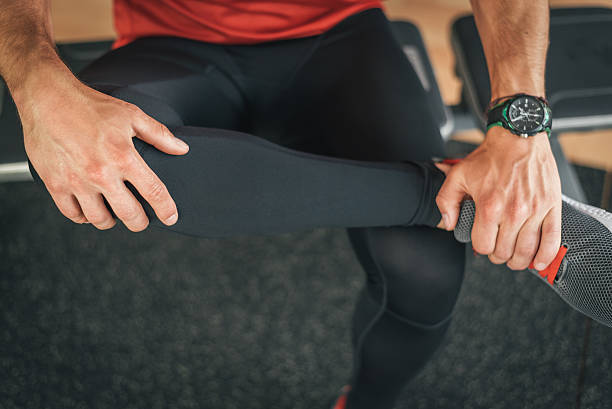 istock Fitness man stretching leg for warming up before gym workout 543083868
