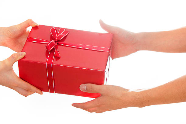 istock Hands giving and receiving a present 543085056