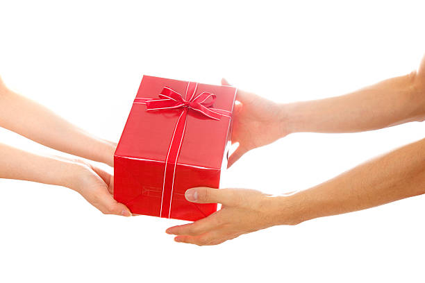 istock Hands giving and receiving a present 543085078