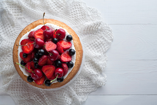 Traditional strawberry cake homemade gourmet sweet dessert bakery food decorated with berries and whipped cream on white background table