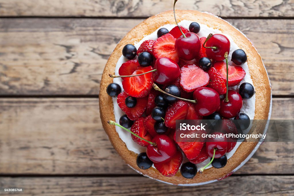 Fresh strawberry cake homemade traditional gourmet sweet dessert bakery food Fresh strawberry cake homemade traditional gourmet sweet dessert bakery food decorated with berries and whipped cream on rustic background table Cake Stock Photo