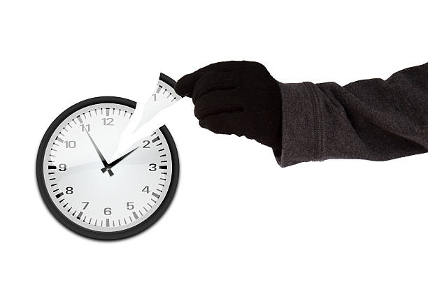 Time thief concept Arm with black glove stealing a piece of a clock time thief concept arm span stock pictures, royalty-free photos & images