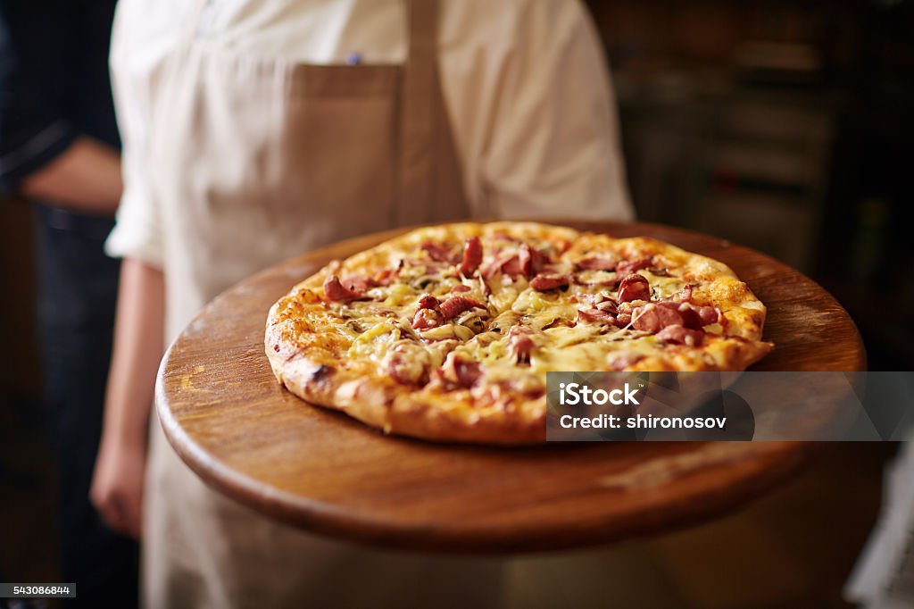 Italian food Fresh Italian pizza served by chef Pizzeria Stock Photo