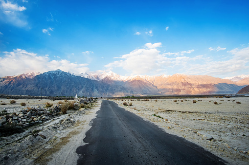 The road (Leh - Manali highway) is serpentine descent to the Pang village - Tibet, Leh district, Ladakh, Himalayas, Jammu and Kashmir, Northern India