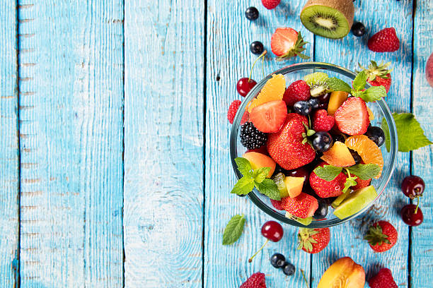 istock Fresh fruit salad served on wooden table 543173656