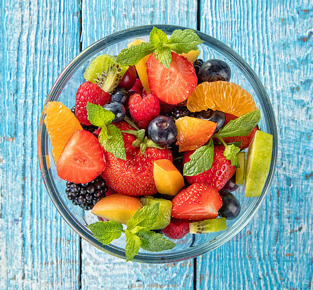 istock Fresh fruit salad served on wooden table 543173736