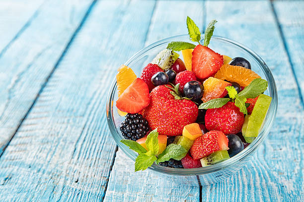 Fresh fruit salad served on wooden table