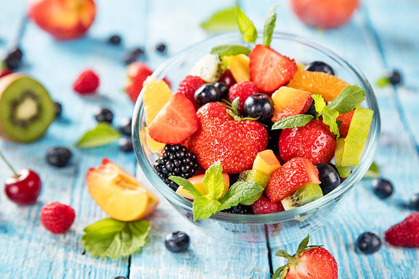 istock Fresh fruit salad served on wooden table 543173828