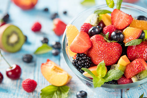 istock Fresh fruit salad served on wooden table 543173852
