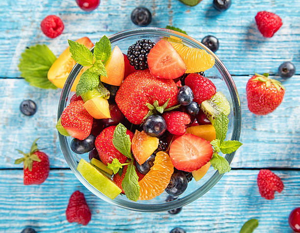 istock Fresh fruit salad served on wooden table 543173900