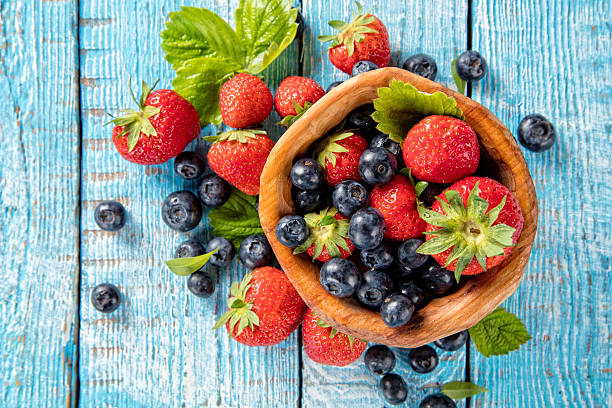 istock Berry fruit in saucer placed on old wooden planks 543175310