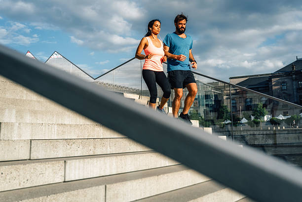 istock Young female and male running 543176062