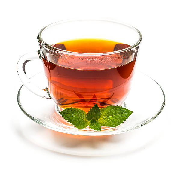 istock Transparent cup of tea and mint leaves on white 543176266