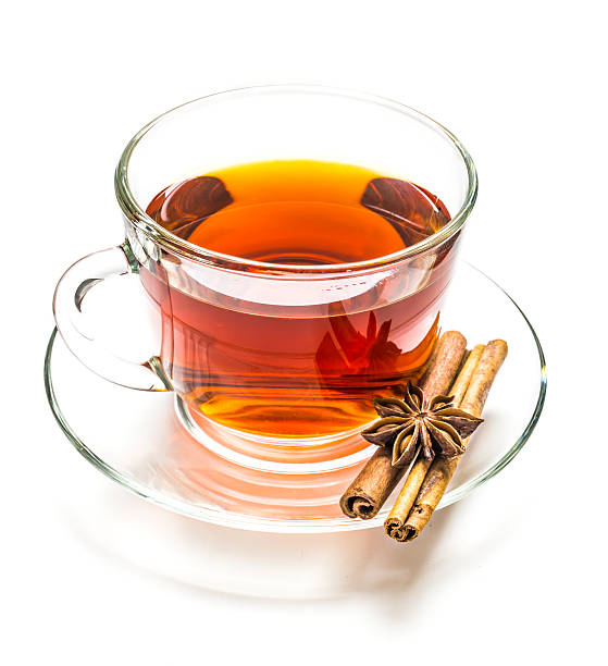 istock Transparent cup of tea and cinnamon steaks on white 543176320