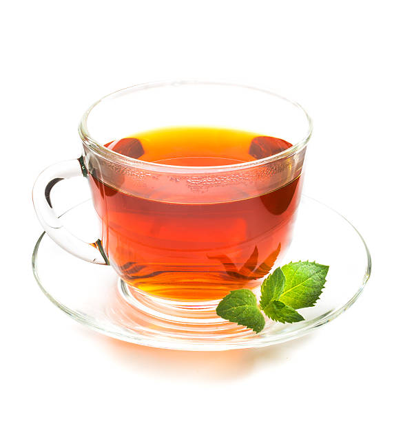 istock Transparent cup of tea and mint leaves on white 543176340