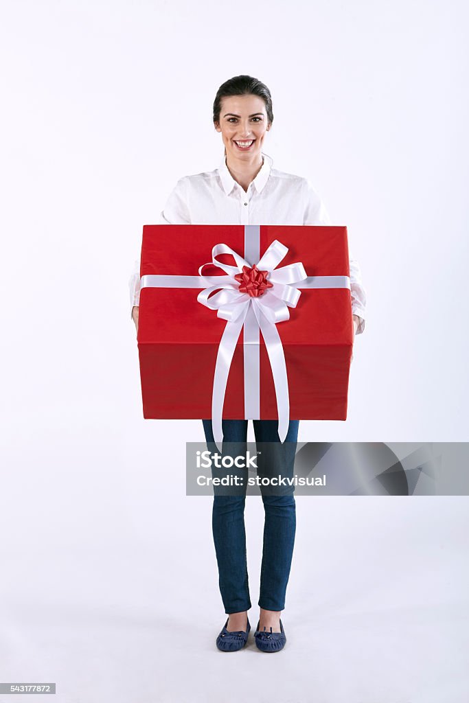 White shirt women holding big red gift box Woman holding a gift box and smiling 20-29 Years Stock Photo